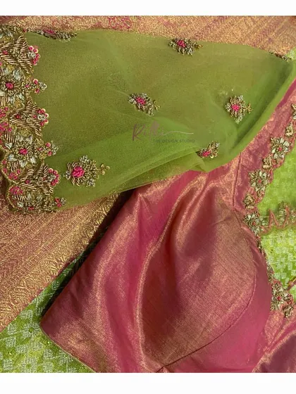 A beautiful flat lay showing the embroidery details on a sheer green sleeve and the matching pink silk body of the blouse.