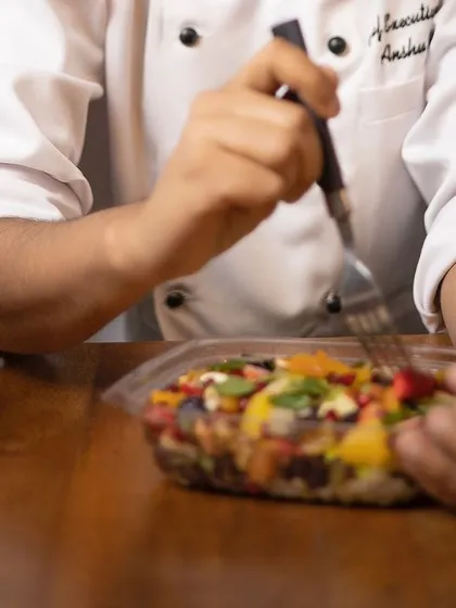 A close-up of our chef enjoying a well-deserved meal. It's a reminder of the love and dedication that goes into every dish we serve.