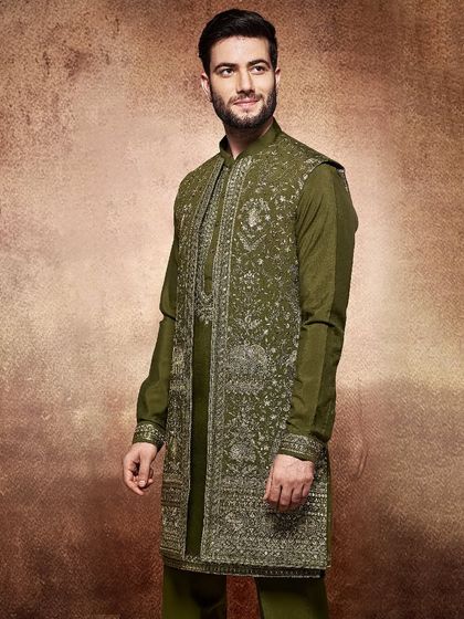Earthy and elegant, this olive green kurta and embroidered jacket set is for the groom who dares to be different. The silver embroidery provides a beautiful contrast against the deep green.