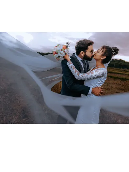 The timeless elegance of a Christian wedding. We use dramatic lighting and composition, like this shot with the bride's veil, to create cinematic portraits that feel both classic and modern.