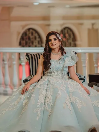 Seated like royalty, the bride's makeup is chic and elegant. The look is perfect for a grand engagement celebration.