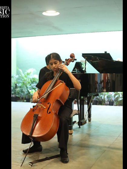 A young cellist performs with focus and poise. Our program is designed to build not just technical skill but also the stage presence required of a confident musician.