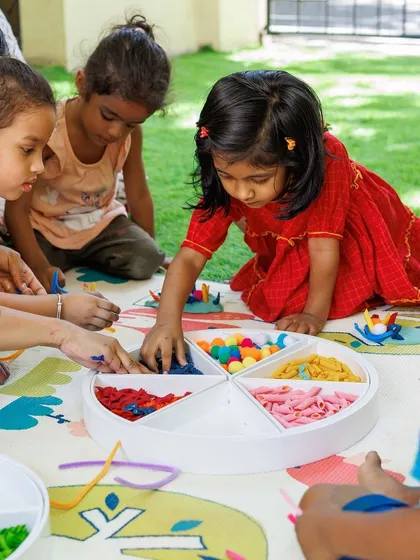 A glimpse into our group activities where children learn to share and create alongside one another. This colorful, multi-sensory setup encourages fine motor skill development as they pick, place, and sort different materials.