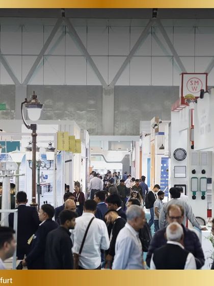 The aisles are filled with curious visitors exploring a diverse range of lighting products, from commercial to decorative.