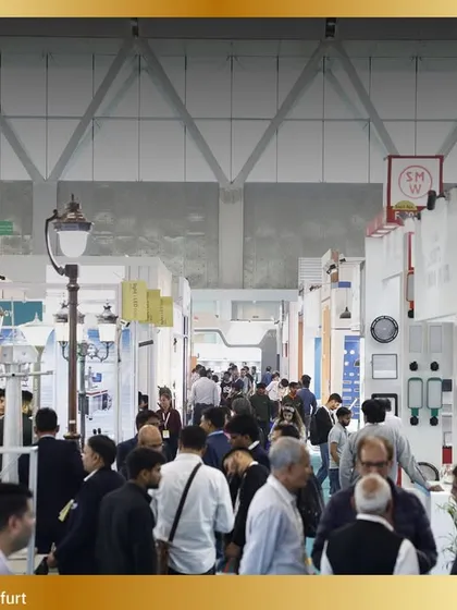 The aisles are filled with curious visitors exploring a diverse range of lighting products, from commercial to decorative.