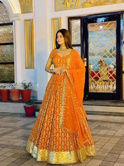 Another full-length shot of the elegant orange lehenga.