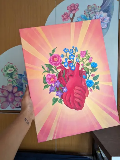 This piece, 'The Heart's Embrace,' is a deeply personal acrylic painting on canvas. It represents healing and growth, with flowers blooming from an anatomical heart.