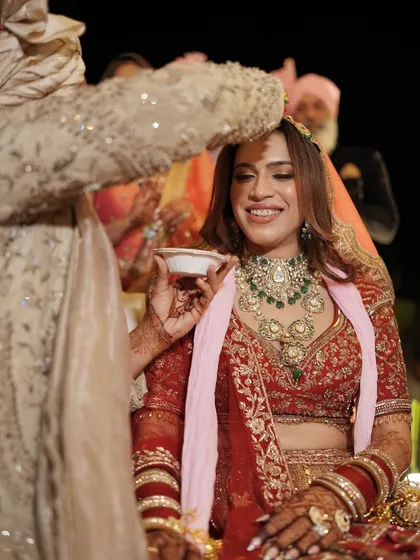 A beautiful moment during the wedding rituals. The soft glam makeup lets her inner light shine through, making her look elegant and full of happiness.