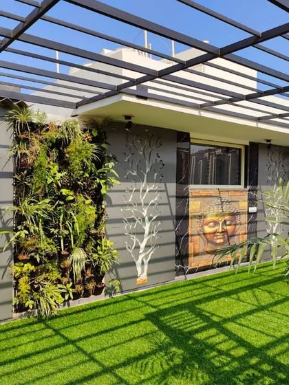Another angle of the feature wall, highlighting the texture of the vertical garden and the intricate details of the backlit art pieces.