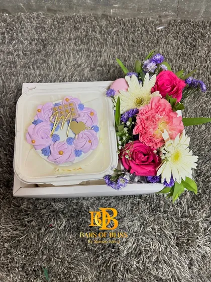 A top-down view of the bento cake and flowers inside the hamper box.