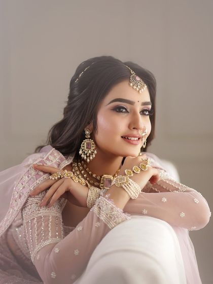 A beautiful portrait of the bride, her smile lighting up the frame. The soft makeup enhances her natural beauty.