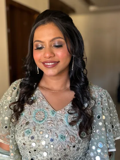 A close-up of a beautiful soft glam look. The client is wearing a mirror-work lehenga, and I used a shimmery champagne eyeshadow and a warm nude lip to complete the look.