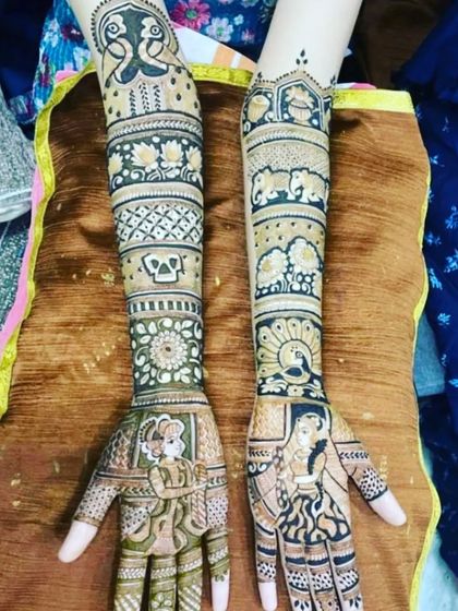 A mix of styles, this design includes portraits on the palms and traditional motifs like peacocks and elephants on the arms.