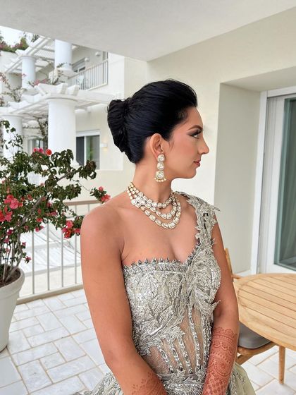 A side profile of the elegant French knot, a perfect choice for a modern, fashion-forward bride.