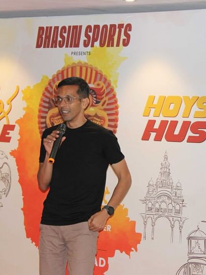 An experienced runner from the community speaking at our launch event. We value the insights and participation of veteran runners in shaping our races.