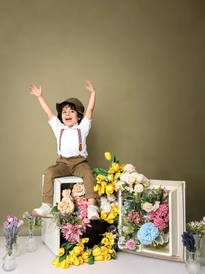 The boy raises his arms in celebration, a shot filled with pure, uncontainable childhood joy.