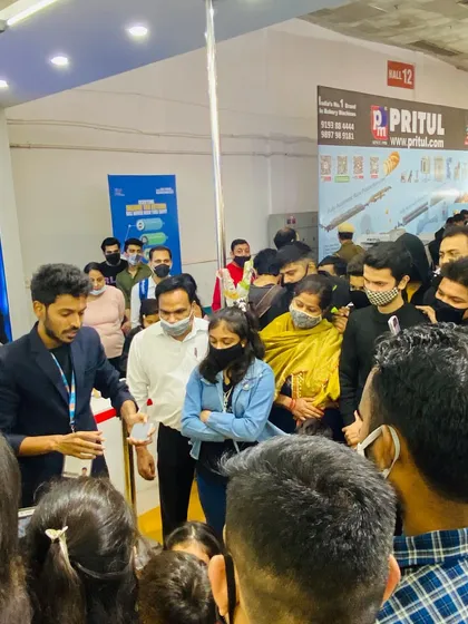 Interacting with attendees at the Pritul booth. My presence helps create a friendly and approachable atmosphere, making it easier for your sales team to connect with visitors.