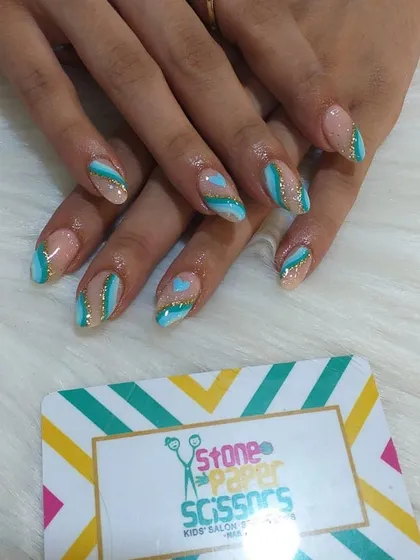 This design uses a beautiful combination of teal and gold glitter. The diagonal stripes and heart shape create a modern and playful look on these almond-shaped extensions.