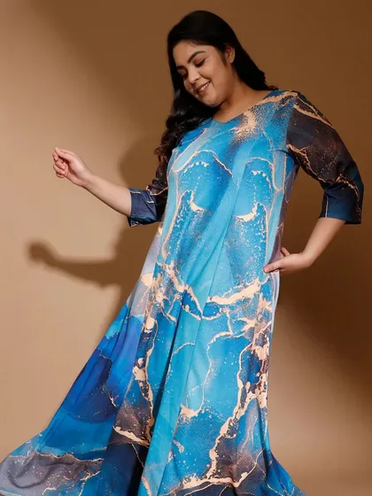 This flowy plus-size dress features a vibrant blue marble print, offering a modern twist on ethnic wear. The A-line cut ensures a comfortable fit that drapes beautifully, giving you confidence and freedom of movement.