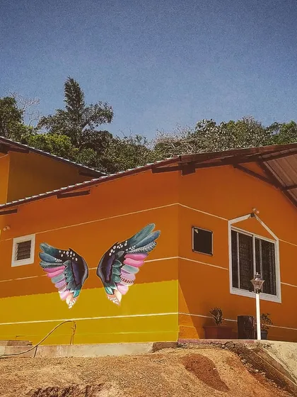 We gave this beautiful homestay in Sakleshpur a signature photo spot with these colorful wings. The art pops against the building's bright exterior and the natural scenery, making it an irresistible spot for guest photos.