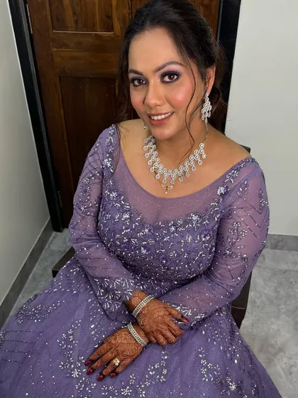 A stunning reception look in a lavender gown with sparkling details. The makeup features a beautiful purple smokey eye.