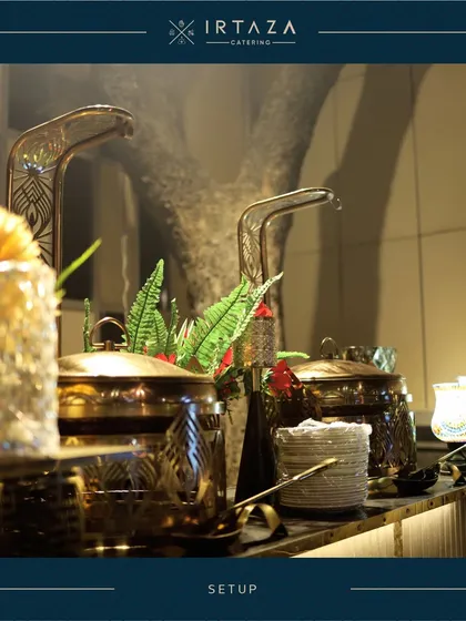A detailed shot of the unique, artistic handles on my golden serving pots. It's small details like these, combined with fresh greenery, that contribute to a truly bespoke and high-end catering presentation.
