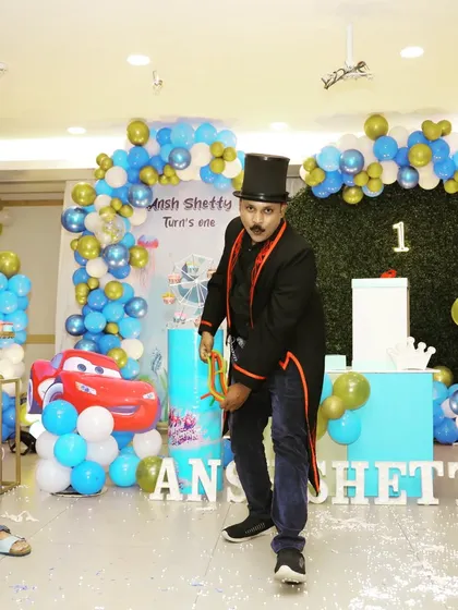 A dynamic pose during the linking rings routine. I bring a lot of energy and showmanship to every performance to keep the party atmosphere going.