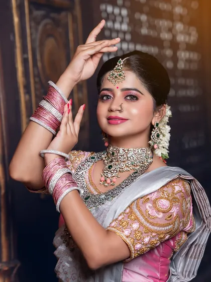 A graceful pose highlighting the jewellery and makeup.