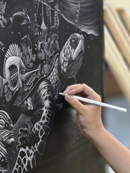 This macro shot highlights the fine lines and textures created with a white pencil, demonstrating how the artist rendered the turtle's skin and the fish's scales.