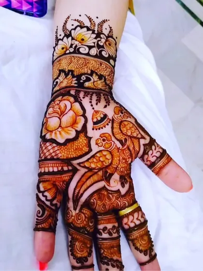 A beautiful Arabic-style design for the back of the hand. The pattern features a large rose and a pair of parrots, creating a design that flows elegantly from the wrist to the finger.