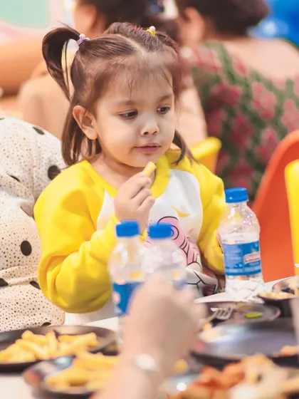 A young guest enjoys some french fries at a Peppa Pig party. Our menu has plenty of delicious options to satisfy even the pickiest eaters.