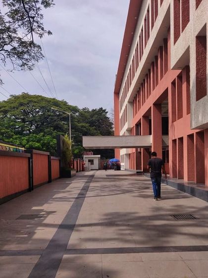 A ground-level view of the WeWork building, showing the updated entryway and the rhythmic pattern of the new facade.
