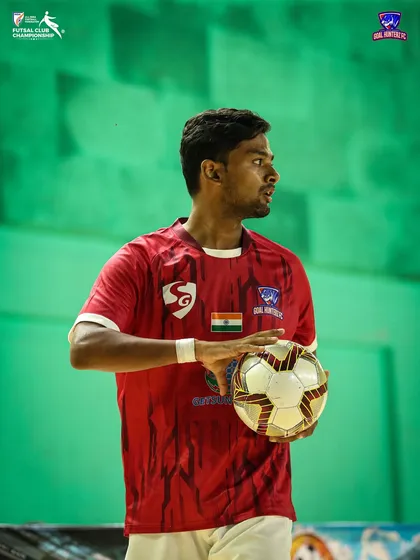 A player holding the ball, looking for a pass.