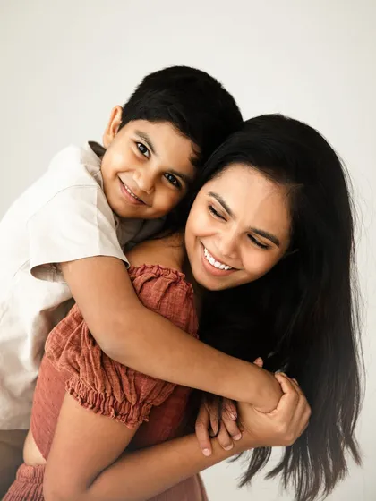 A gentle hug and a happy smile. This portrait perfectly captures the warmth and affection in the relationship between a mother and her son.