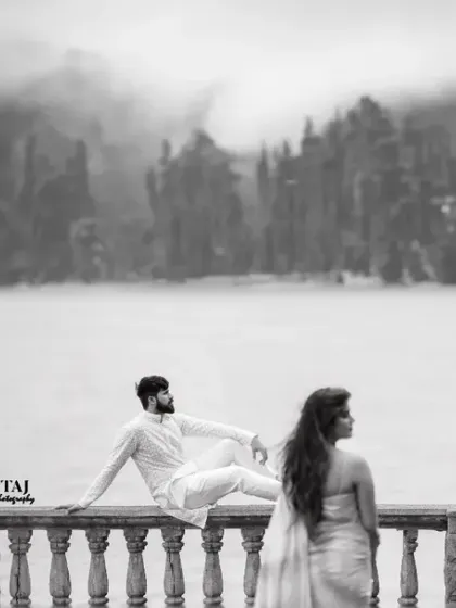 A stunning black and white landscape shot at a misty lake. The serene, foggy backdrop creates a moody and dramatic atmosphere for this unique pre-wedding portrait.