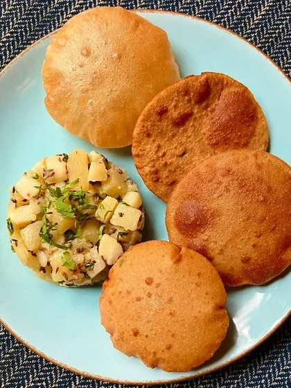 Savor the essence of the Shravan season with our Farali Puri Bhaji. We serve crispy puris made from fasting-friendly flour alongside a flavorful, spiced potato bhaji.