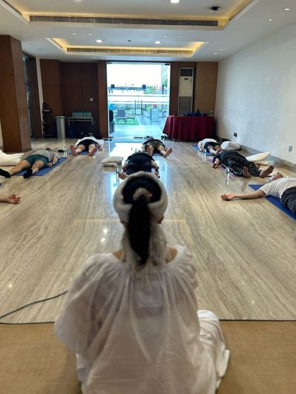 Holding space for deep relaxation (Shavasana) during a corporate wellness session. It's a reminder that true change begins with stillness.