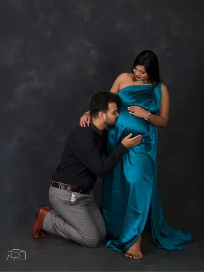 The classic bump kiss. This tender moment is a must-have in any couple's maternity session, filled with love and anticipation.