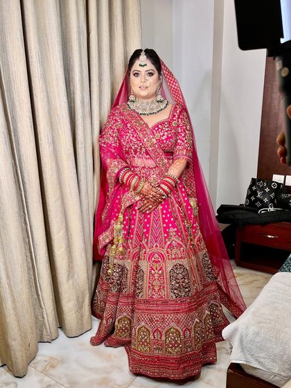 A full view of our bride in her magnificent pink lehenga. The soft smokey eyes and luminous skin create a perfect balance for this grand bridal look.