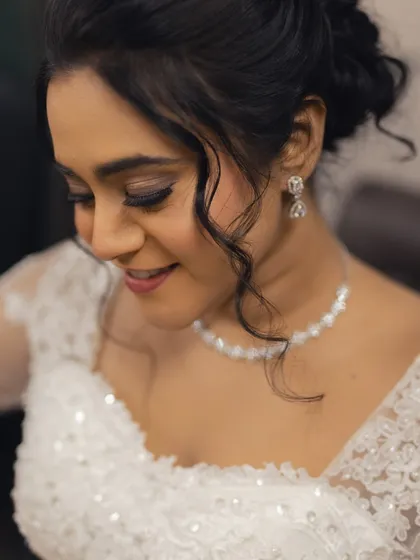 A close-up of Steffi's makeup and hairstyle. The soft curls framing her face add a touch of romance to the look.