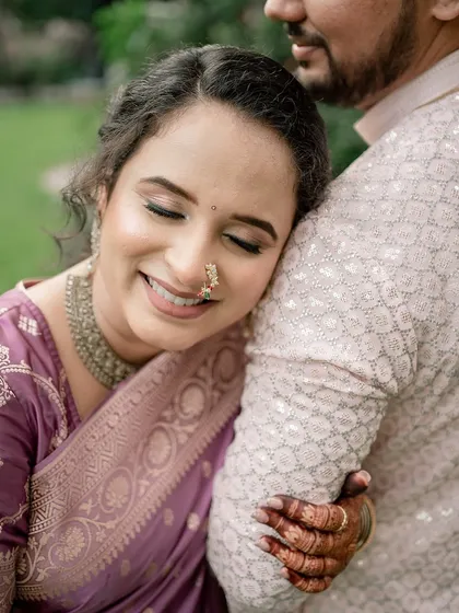A soft, dreamy, and oh-so-glowy engagement look for a Maharashtrian bride. This candid moment captures the romance and happiness of the day.