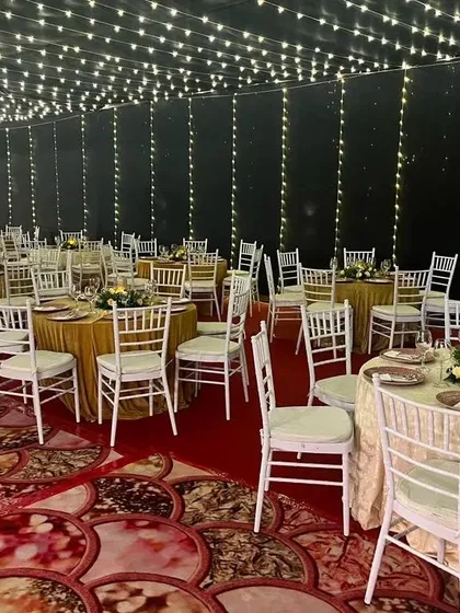 A wider view of the dining area for Evanna's communion. The room is decorated with a ceiling of fairy lights and white cherry blossom trees, creating a magical, starry-night effect for the celebration.