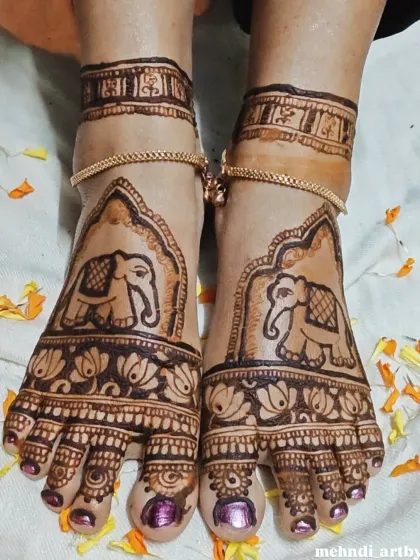 For a truly grand look, I create full coverage foot mehendi. This design features majestic elephants framed by architectural patterns, extending from the toes to the ankles for a complete bridal or festive style.
