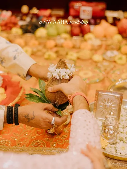 A close-up of the coconut ritual, a significant part of many Hindu wedding ceremonies.