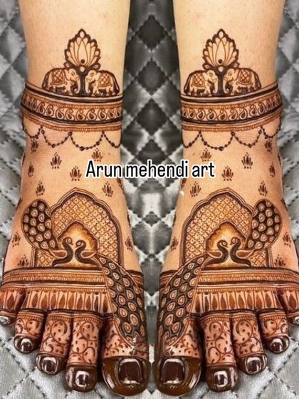 This foot design features graceful peacocks inside an arched frame, with elephant motifs on the ankle band for an auspicious touch.