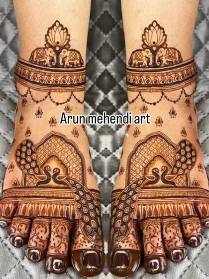 This foot design features graceful peacocks inside an arched frame, with elephant motifs on the ankle band for an auspicious touch.