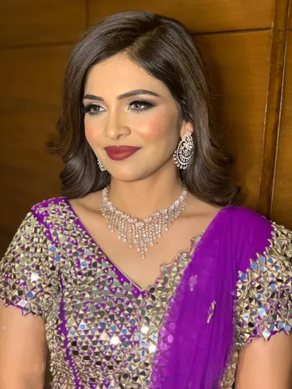 A different angle of Yesha's party look, highlighting the flawless skin and the rich lip color.