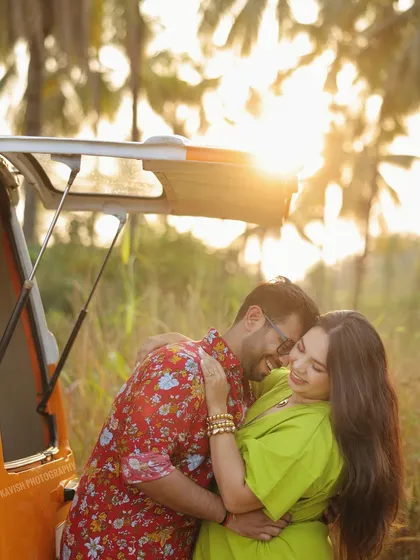 A warm, sun-kissed pre-wedding portrait capturing a candid embrace in a field at golden hour. This image showcases my love for using natural light to create authentic and romantic moments outdoors.