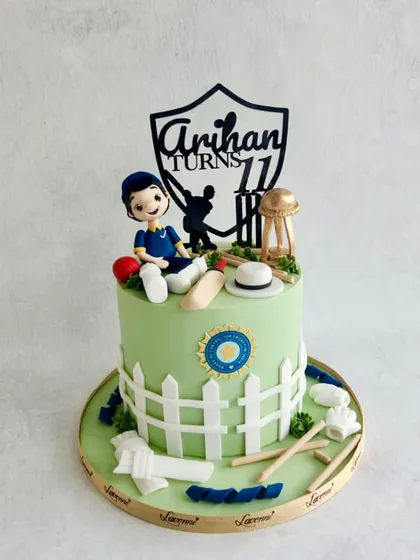 A cricket-themed cake for Arihan's 11th birthday, with a fondant figurine, a picket fence, and cricket equipment.