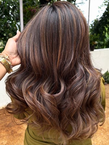 Getting her 'Vacay Hair' on with these beautiful ribbon highlights. This technique creates a gorgeous, flowing look that’s perfect for showing off on your next trip.